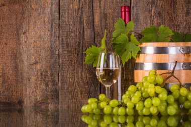 Grapeleaves tarafından gizli bir varil beyaz şişe şarap
