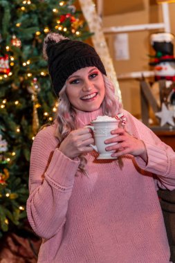 Muhteşem bir sarışın manken Noel ağacı ve hediyelerle tatilin tadını çıkarıyor.