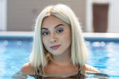 Sarışın bir manken yaz gününün tadını çıkarırken bikiniyle poz verir.