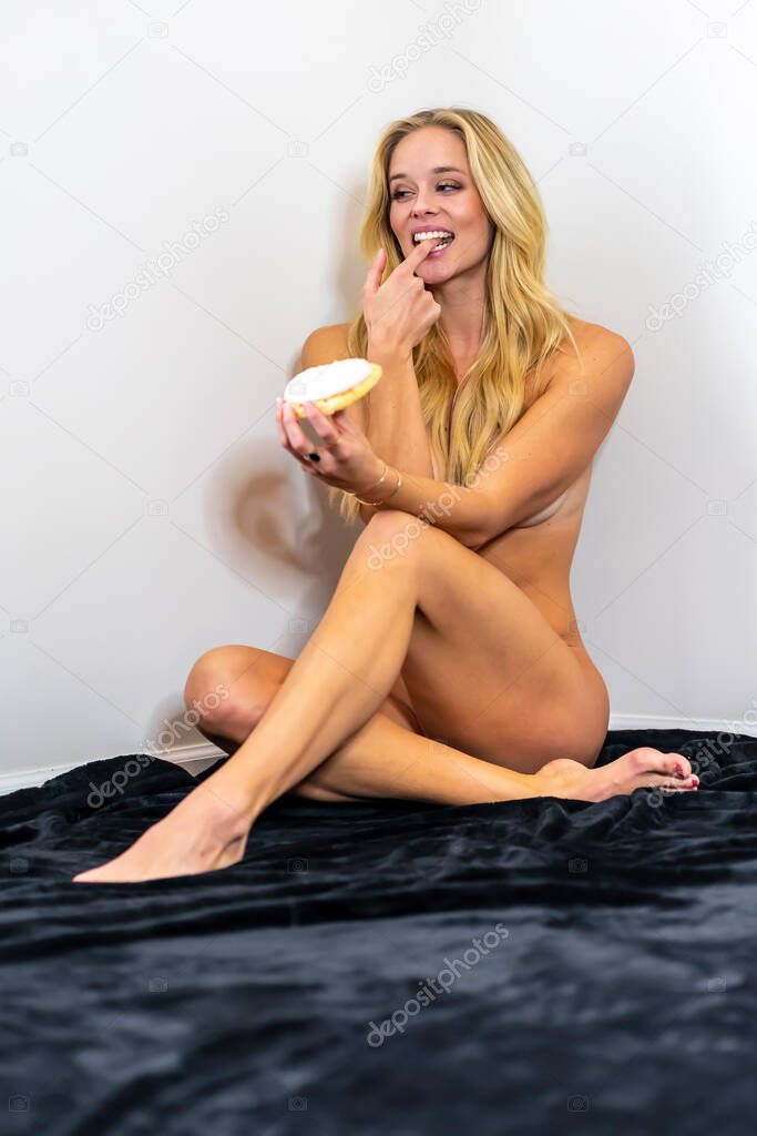 A beautiful nude figure model posing in a studio environment