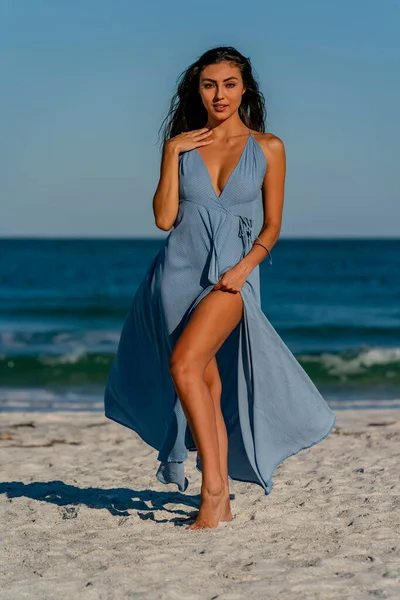 A beautiful mixed race bikini model enjoys the weather outdoors on the beach