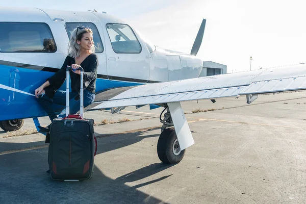 豪華な若いブロンドモデルは 地元の空港で単一のエンジン航空機で屋外でポーズ — ストック写真