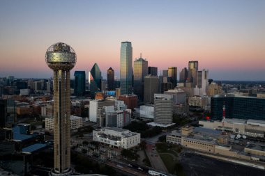 Aerial view of Dallas shows a vast, vibrant metropolis with its iconic skyline, sweeping highways, and sprawling suburbs, highlighting the DFW region as a major inland hub of industry, transit, and culture.