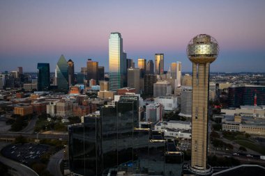 Aerial view of Dallas shows a vast, vibrant metropolis with its iconic skyline, sweeping highways, and sprawling suburbs, highlighting the DFW region as a major inland hub of industry, transit, and culture.
