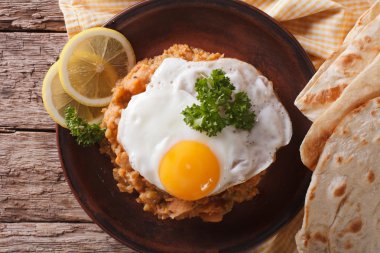Egyptian breakfast: ful medames with egg close-up. horizontal to clipart