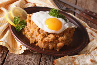 ful medames bir sahanda yumurta ve pide ile kapatın. Yatay