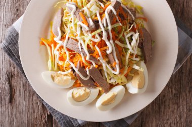 Beef heart with vegetables close-up on a plate. Horizontal top v