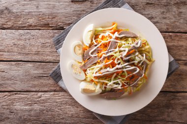 Salad from beef heart with eggs and vegetables. horizontal top v