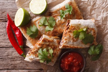 Mexican spicy chimichanga with meat and vegetables. horizontal t