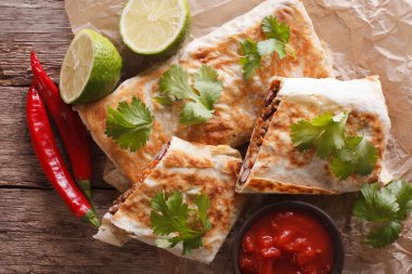 Hot chimichanga with meat and vegetables close-up. horizontal to