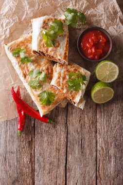 Mexican spicy chimichanga with meat and vegetables. Vertical top