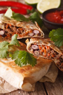 chimichanga with ground meat, beans and cheese macro. vertical