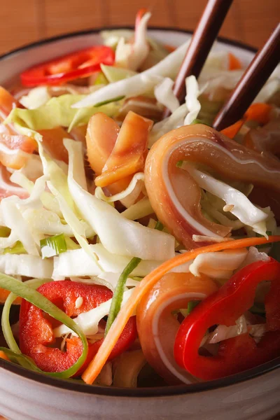 Salad with pig ears and vegetables in a bowl macro. vertical — Stock Photo, Image