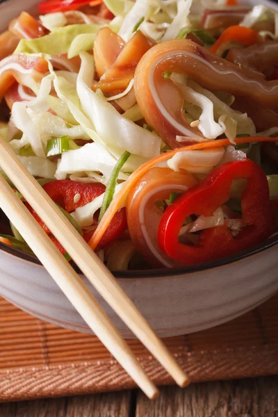 Asian Pig ears salad with fresh vegetables in a bowl macro. vert — Stock Photo, Image