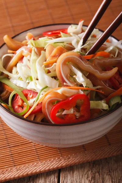 Salad of pork ear and vegetables close-up in a bowl. vertical — Stock Photo, Image