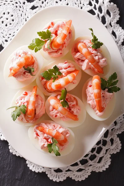 Eggs stuffed with shrimp close-up on a plate. vertical top view — Stock Photo, Image