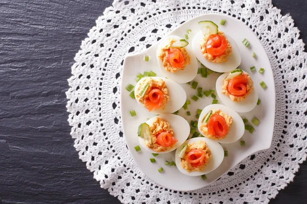 Eggs stuffed with salmon, cheese and cucumber. horizontal top vi — Stock Photo, Image
