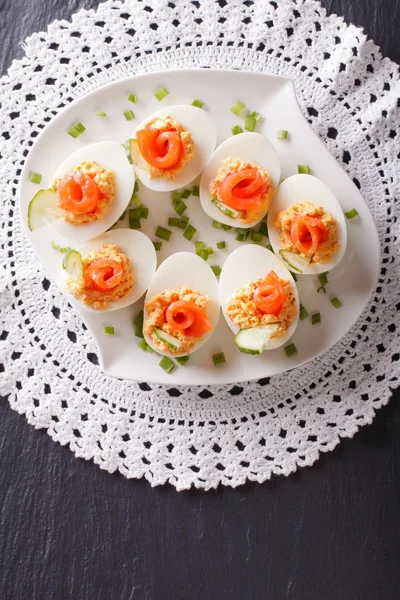 Eggs stuffed with salmon, cheese and cucumber. vertical top view — Stock Photo, Image