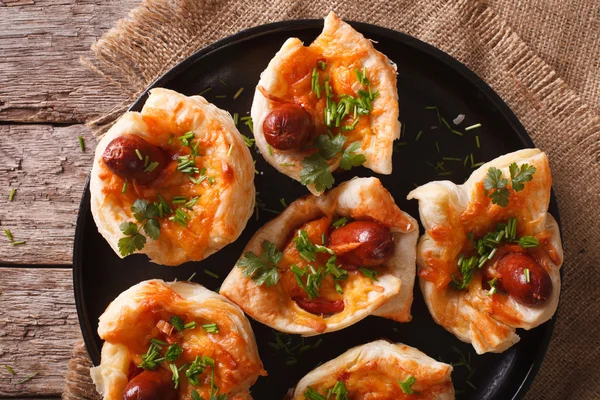 Muffins stuffed with sausage and cheese close-up. Horizontal top — Stock Photo, Image