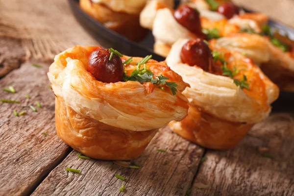 Muffins of puff pastry with sausage and cheese close-up. horizon — Stock Photo, Image