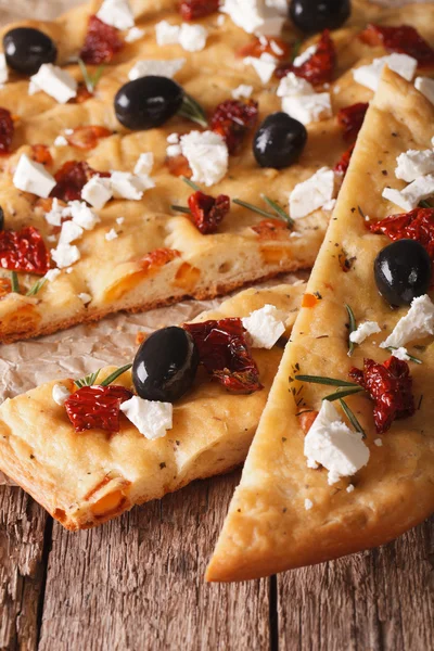 Focaccia with dried tomatoes, feta and olives. macro vertical — Stock Photo, Image