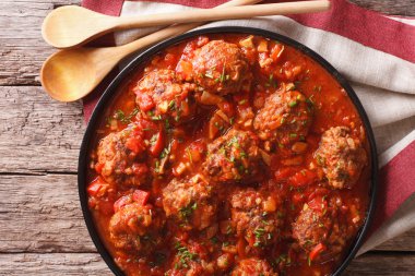 Tasty food: Meatballs albondigas with tomato sauce close-up. hor clipart