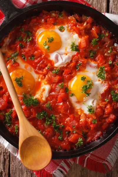 Shakshuka fritou a macro de ovos em uma panela de ato de fritar. vista superior vertical — Fotografia de Stock