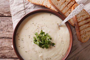 White vegetable cream soup close up in a bowl. horizontal top vi