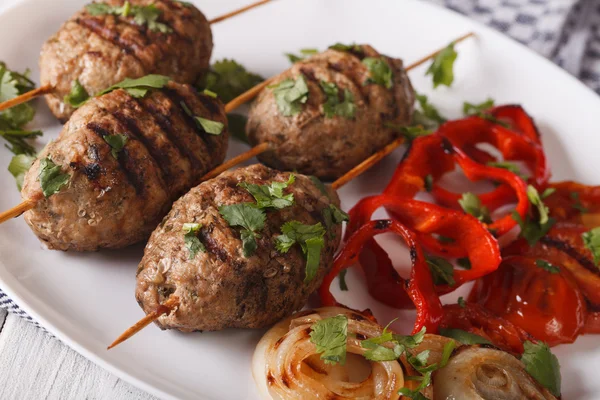 Kofta kebab with grilled vegetables on a plate close-up. horizon — Stock Photo, Image