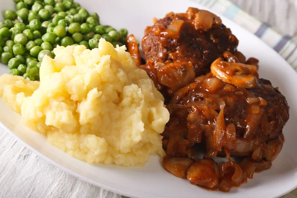 Salisbury steak with mashed potatoes and green peas close-up on — Stock Photo, Image