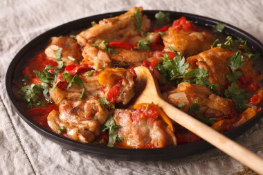 Chicken stew with vegetables and spices - chakhokhbili close-up. clipart