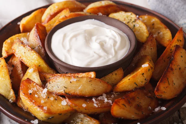 Baked potato wedges and sauce on a plate macro. Horizontal — Stock Photo, Image