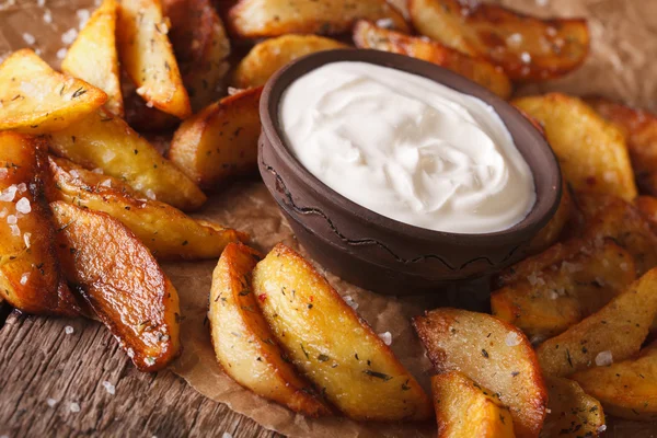 Fast food: Potato wedges and mayonnaise close-up. horizontal