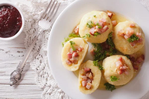 Tasty potato dumplings with bacon and parsley topped with butter — Stock Photo, Image
