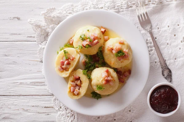 Potato dumplings stuffed with ham, bacon and onion close-up. hor — Stock Photo, Image