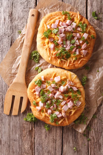 Langos deep fried with cheese and ham close-up. Vertical top vie — Stock Photo, Image