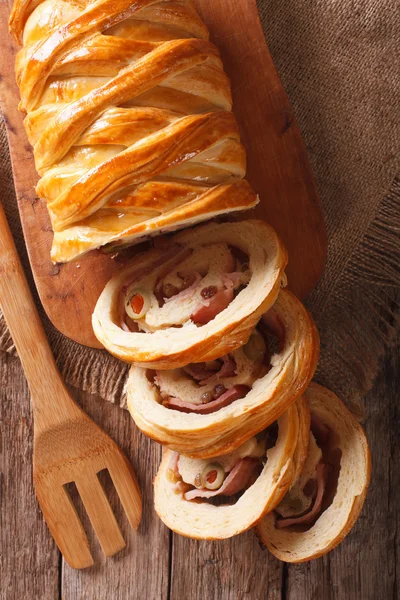 Venezuelan cuisine: Christmas loaf pan de jamon close-up. Vertic — Stock Photo, Image