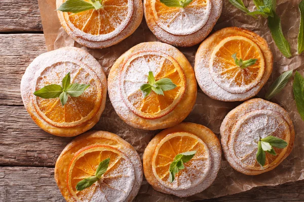 Cookies with orange slices and mint close-up paper on the table. — Stock Photo, Image