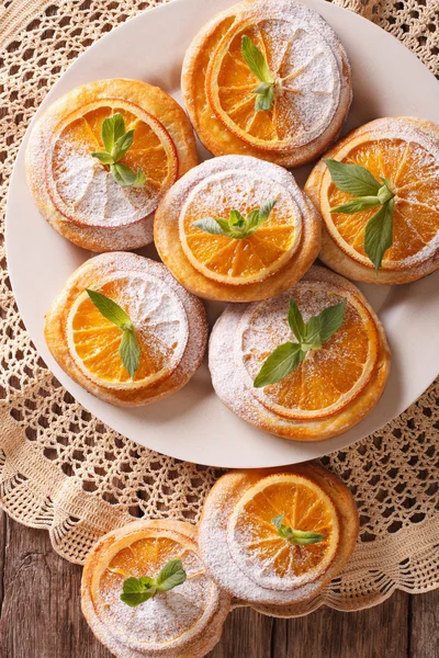 Galletas festivas con naranjas de primer plano en un plato. Parte superior vertical vi — Foto de Stock