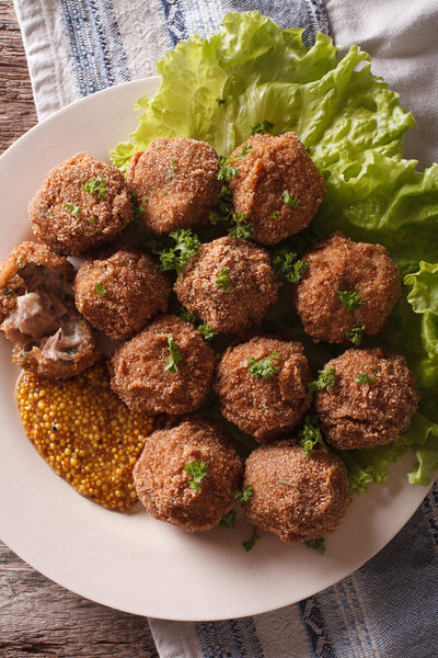 Tasty meat balls Bitterballen and mustard close up on a plate. v