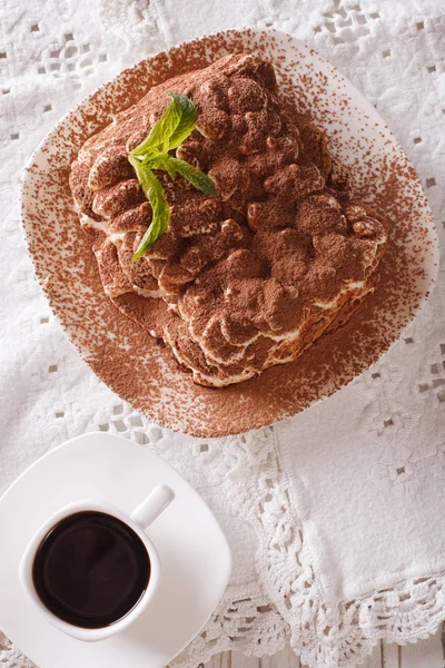 Tiramisu on a plate and espresso coffee on a table close-up. ver — Stock Photo, Image