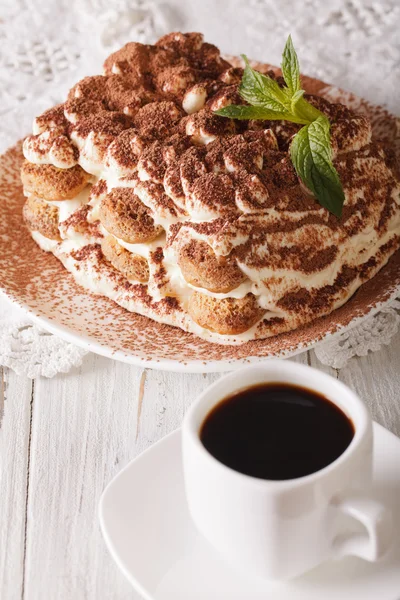 Italian Tiramisu cake on a plate and cup of black coffee close-u — Stock Photo, Image