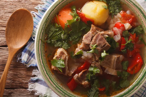 Lamb soup with vegetables closeup at the plate on the table. hor — Stock Photo, Image