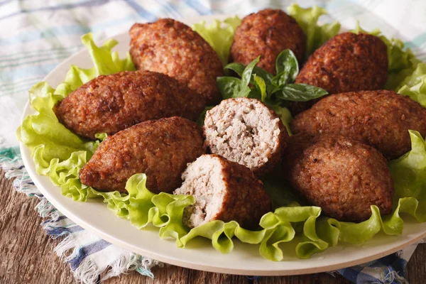 Tasty food kibbeh with bulgur, onion and pine nuts macro. horizo — Stock Photo, Image