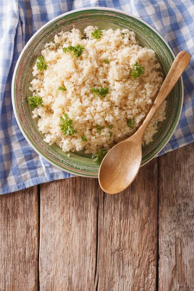 Bulgur al vapore con prezzemolo primo piano su un piatto sul tavolo. ve — Foto Stock