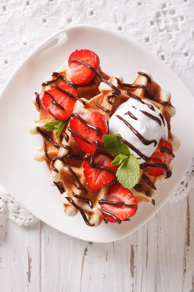 Belgian waffles with strawberries and chocolate topping. vertica