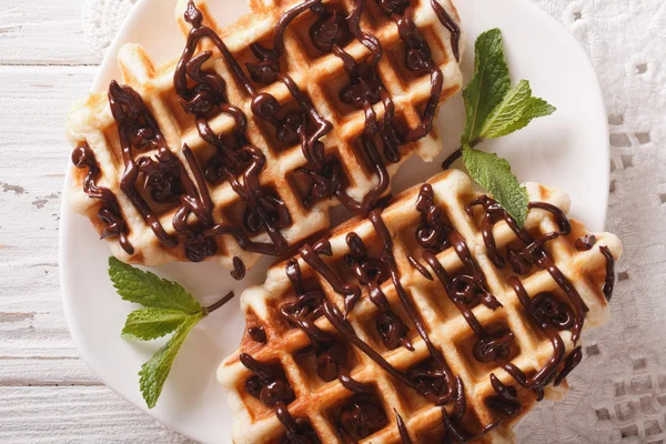 Belgian waffles with chocolate on a plate close-up. horizontal t — Stock Photo, Image