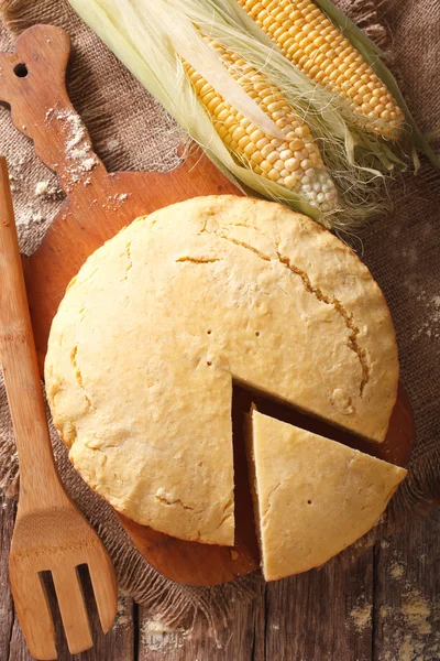 Pane di mais sano fatto in casa primo piano su una tavola di legno. Verticale — Foto Stock