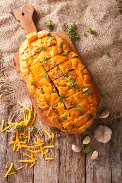 Loaf of bread baked with cheddar cheese, garlic and herbs closeu — Stock Photo, Image