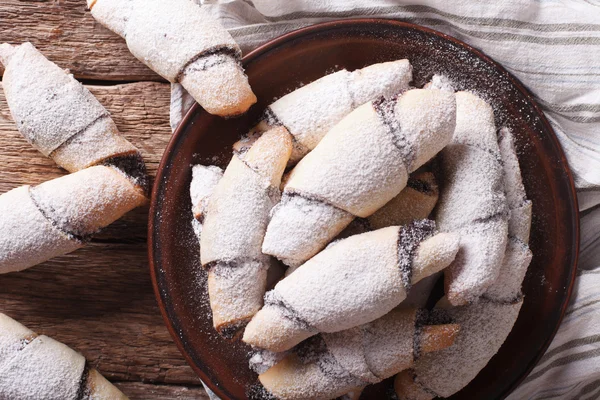 Crescent rolls with poppy seeds macro on a plate. Horizontal top — Stock Photo, Image